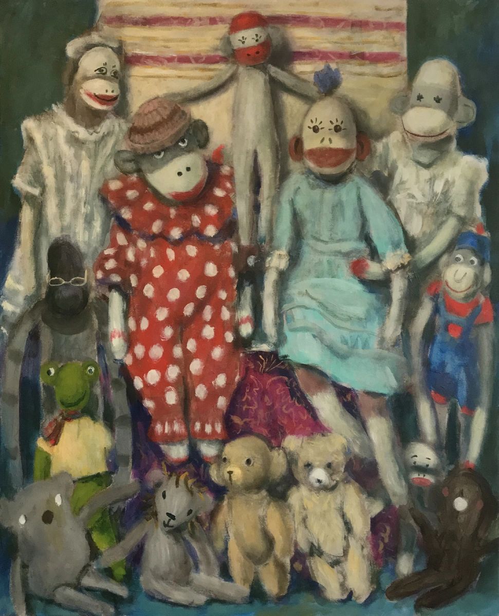A collection of vintage stuffed animals and dolls arranged together.