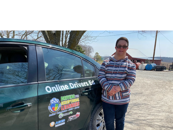 a woman standing in front of a car