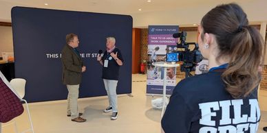 Interview being filmed in a public indoor space.