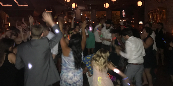 People dancing energetically at a party.