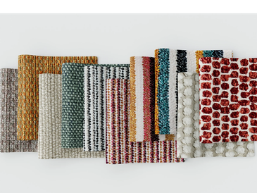 A collection of colorful textured fabric swatches arranged in a row.