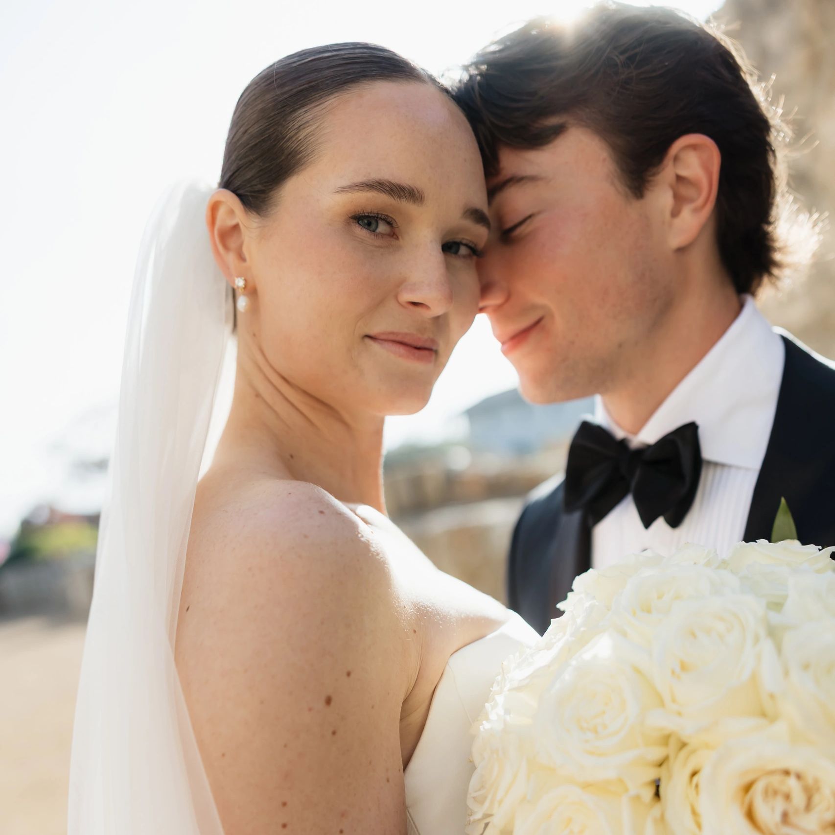 Bride and groom sharing a tender moment on their wedding day.