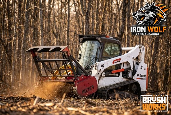A Bobcat machine clearing land in a forest with Iron Wolf and Brush Works logos.