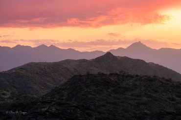 Sunset view of the hills near Phoenix at South Mountain. Layered reds, oranges and yellow