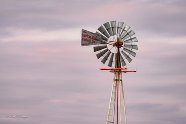 Windmill closeup near dusk in New Mexico. Pinks and Grey
