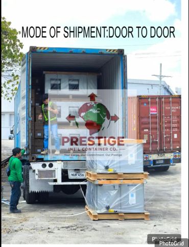 Workers unloading container via door-to-door shipment.