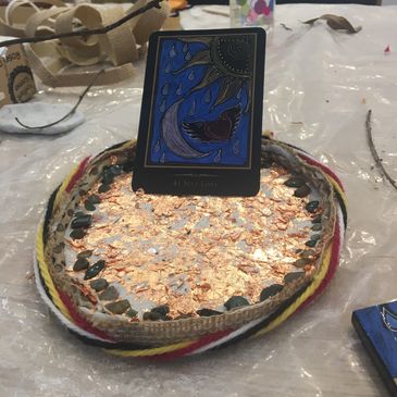 Decorative circular display with card and shiny elements.