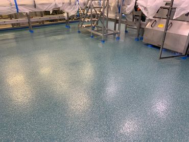 Clean, shiny blue speckled floor in an industrial or kitchen setting.