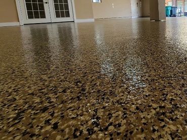 Shiny epoxy-coated garage floor with multicolor flakes.