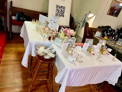 Table displays various perfume bottles and accessories in a boutique.