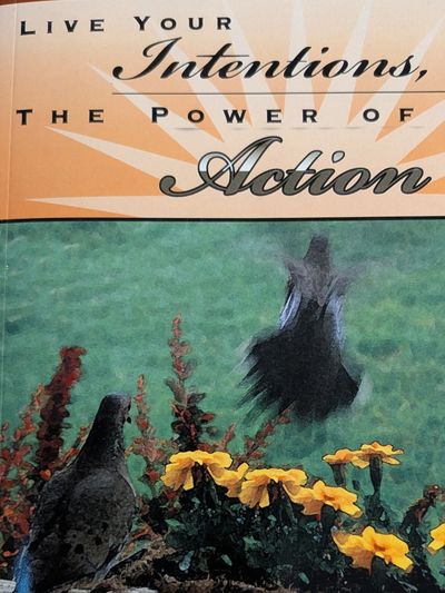 Book cover titled 'Live Your Intentions, The Power of Action' with birds and yellow flowers.