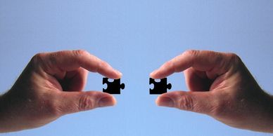 Two jigsaw pieces coming together - Cogs fits into your business model to form a complete structure.