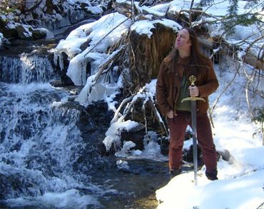 Frank from Medieval/Fantasy Folk/Rock band Elflore in the snow holding a sword.