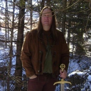 Frank from Medieval/Fantasy Folk/Rock band Elflore holding sword in winter.