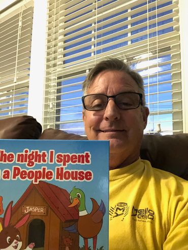 A soon to be grandpa getting the childrens library ready!