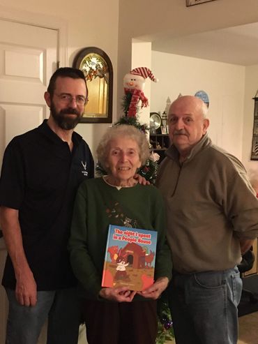 Giving my first childrens picture book, The night I spent in in people house, to Dad and Mom.