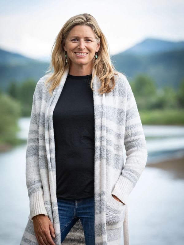 Blonde woman smiling near Snake River in Jackson Hole, Wyoming. Photo: Greg Von Doersten