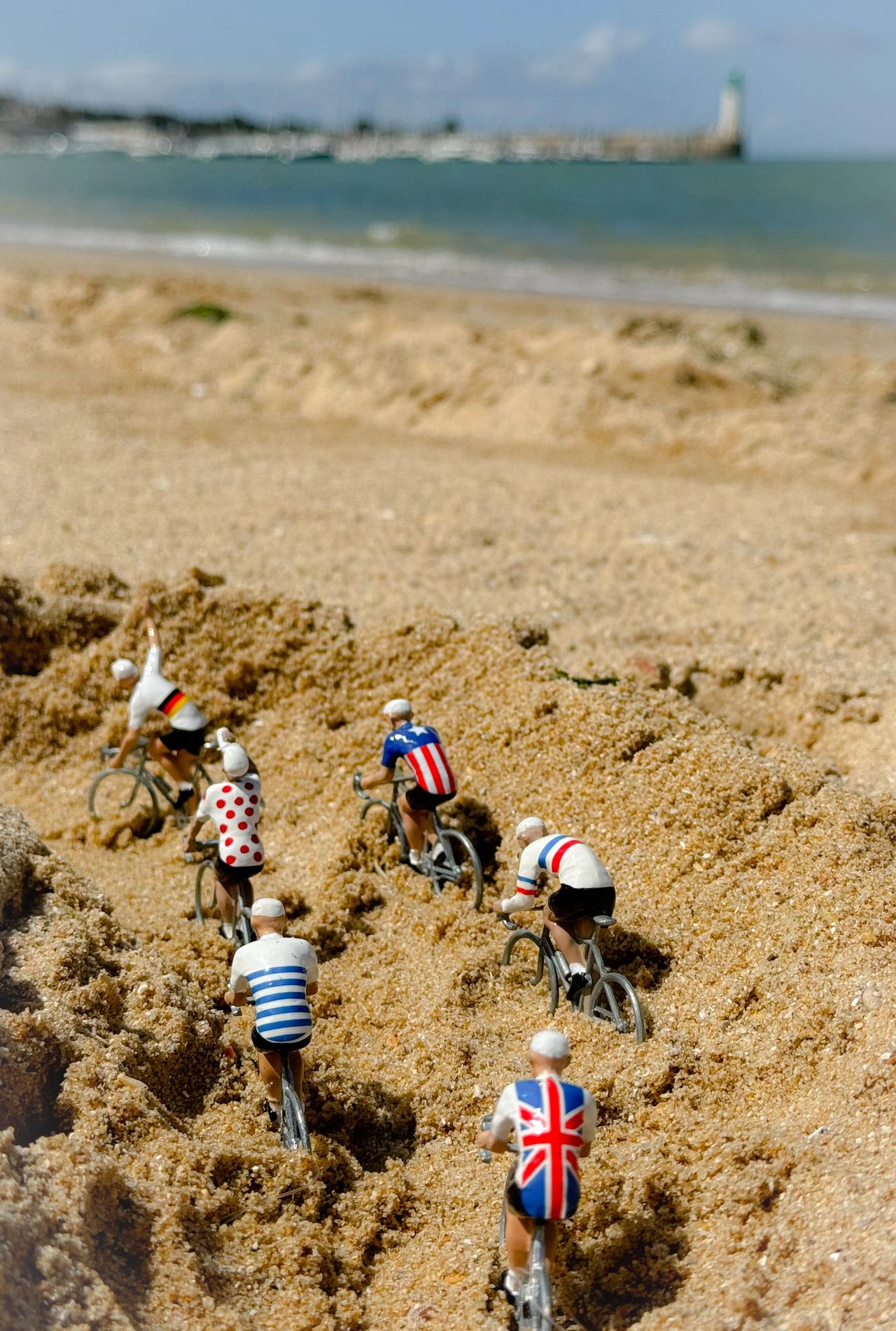 Miniatures from the French "Tour de France" marble game on a sand track