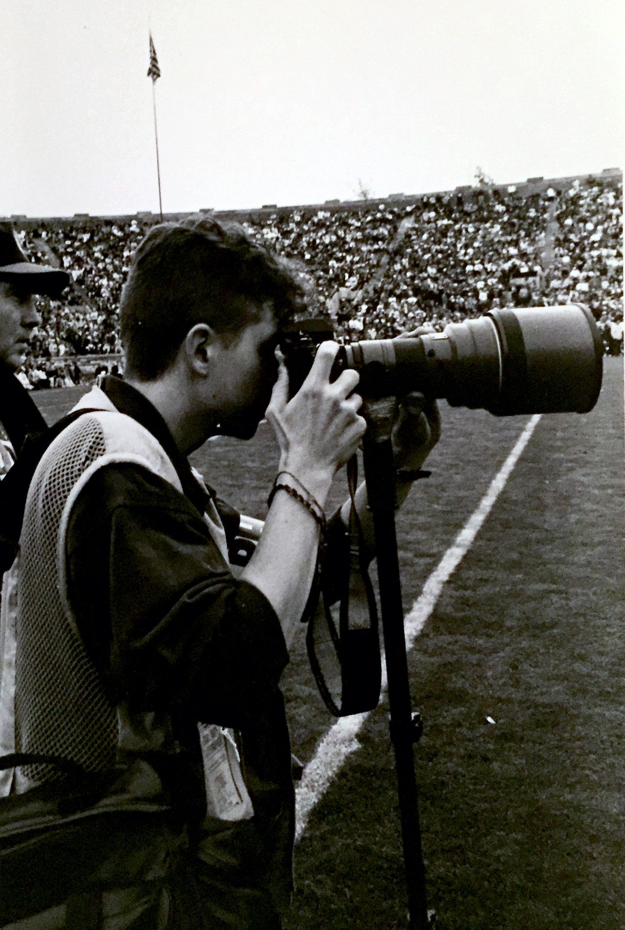 An image of me shooting college football with a Nikon F4 and many rolls of film in my bag