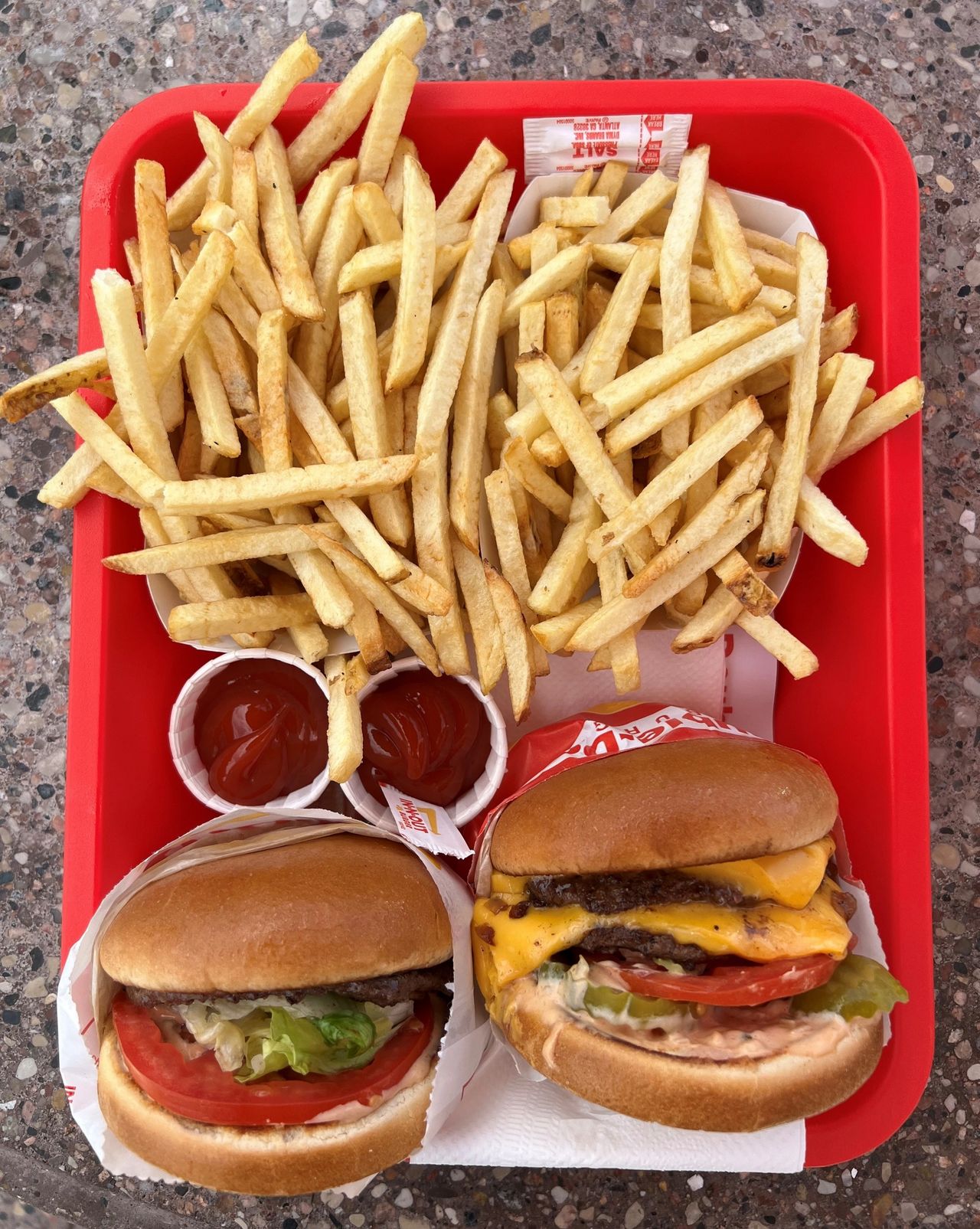 A picture of a Double-Double "Animal-Style" burger (on the right)