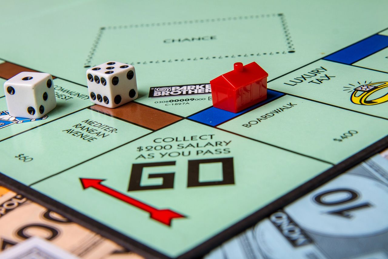 A close-up of a Monopoly board and game pieces (Tracy King - stock.adobe.com)
