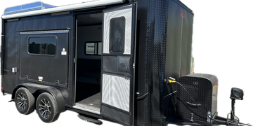 Black All Terrain trailer with open door and tandem torsion axles.  Trailer ordering available 