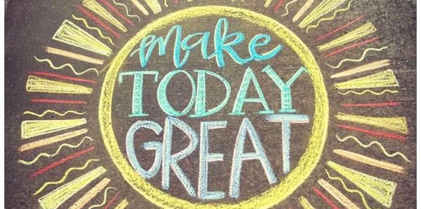 Chalk art of a sun with the words 'Make Today Great' inside.