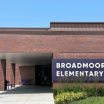 Entrance of Broadmoor Elementary School with a brick facade and sign.