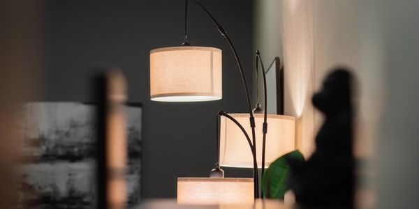 Three modern lamps with warm light in a cozy indoor setting.