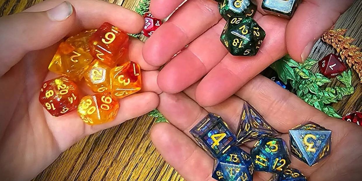 Hands holding colorful dice sets for tabletop games.