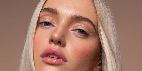 Close-up of a young woman with long blonde hair and natural makeup.