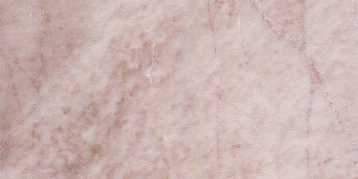 Close-up of a pink marble surface with natural veins.