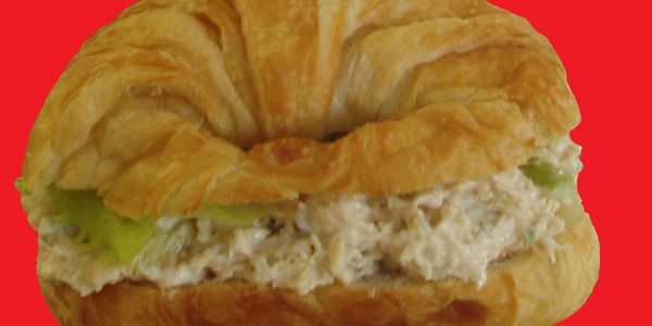 Croissant sandwich filled with creamy chicken salad and lettuce.