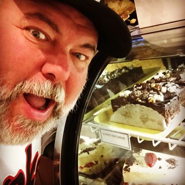 Browsing desserts and local treats during a brewery and food adventure.