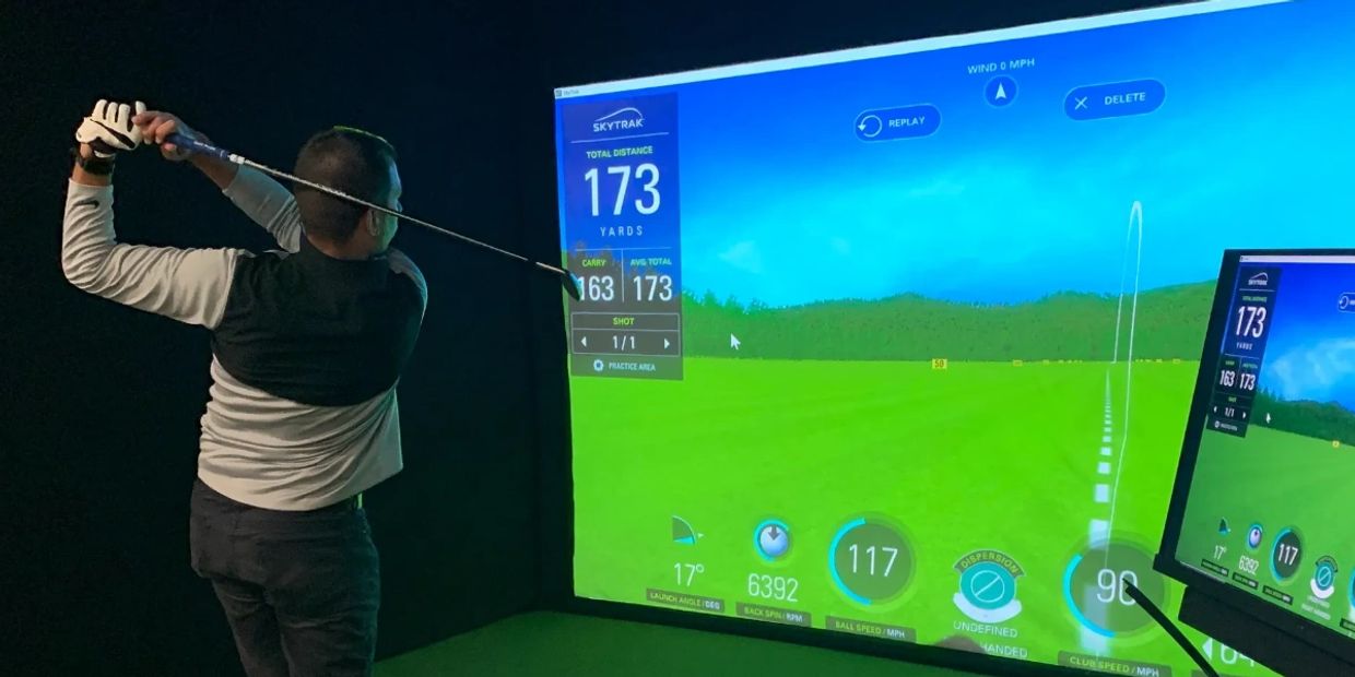 A Man Swinging a Golf Club in a SImulation