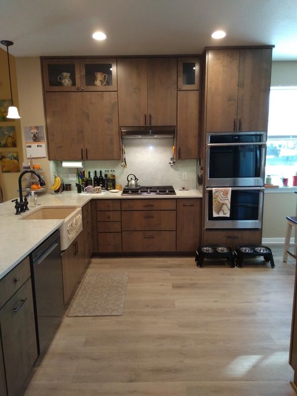Renovated kitchen w/ wooden cabinets, farmhouse sink & recessed lighting by Austin Kitchen and Bath
