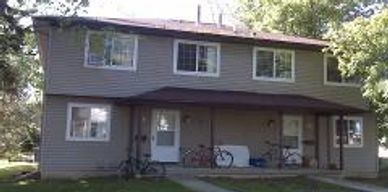 Duplex house with two bicycles outside.