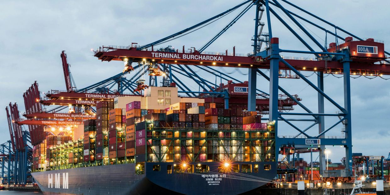 Large container ship HMM Nuri docked at Terminal Burchardkai with cranes unloading cargo.
