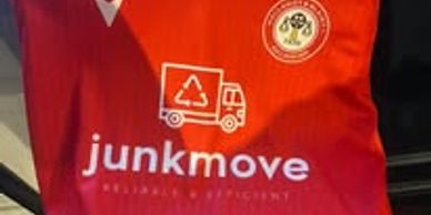 Red shirt with junkmove logo and recycling truck graphic.