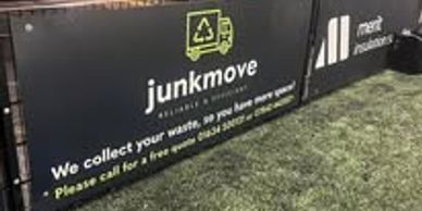 Advertising banner for Junkmove waste collection service on a fence.