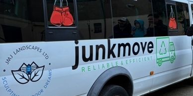 A white van with 'junkmove' and 'JMI Landscapes Ltd' logos parked on the street.