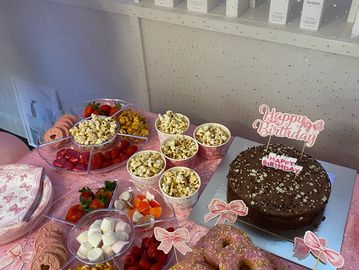 Birthday party setup with cake, snacks, and decorations.