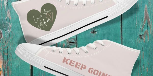 Love You Adam merchandise showing hi tops with green heart and logo and the words Keep Going in pink