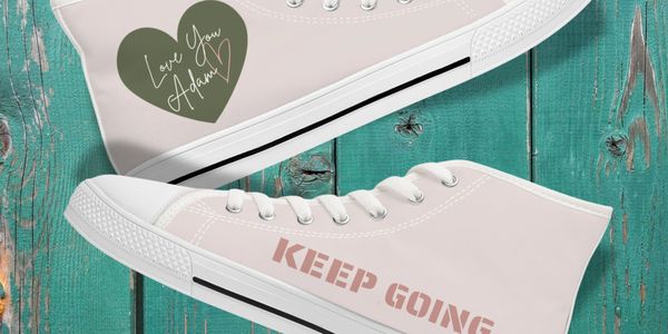 Love You Adam merchandise showing hi tops with green heart and logo and the words Keep Going in pink