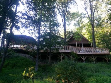 Wooden estate surrounded by trees.