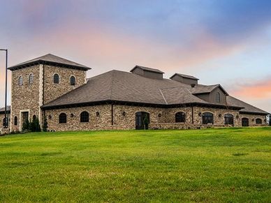 Mansion overlooking a green yard.