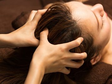 Person getting a relaxing head massage.