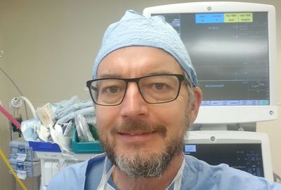 Dr. John Oyston at work in an operating room.