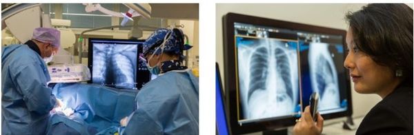 Doctors performing surgery with X-ray images on screen.