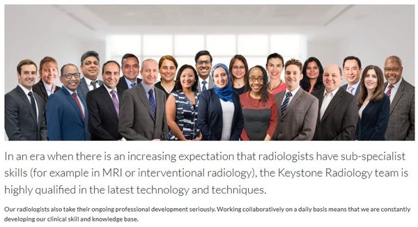 Diverse radiology team in professional attire posing together in a bright office.